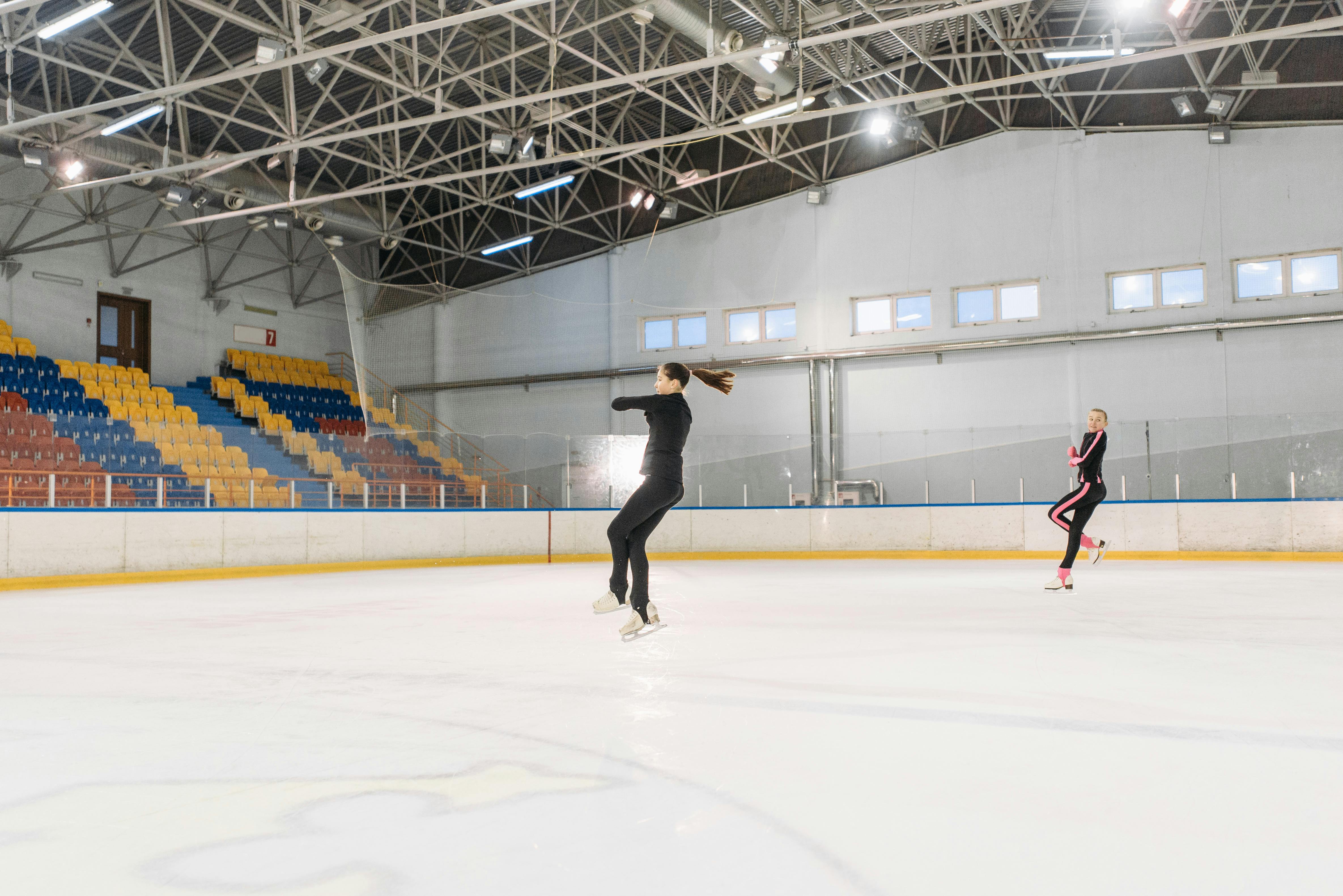 a pair of figure skaters jumping in the air