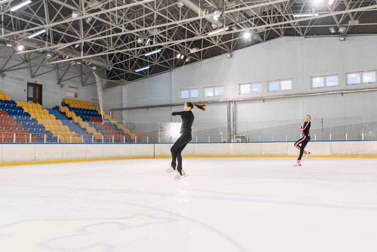 A Pair Of Figure Skaters Jumping In The Air