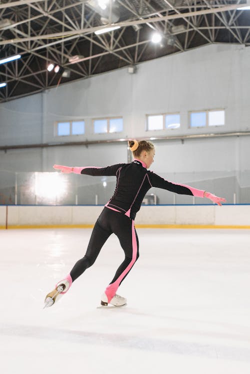 A Woman Ice Skating on the Ice Rink