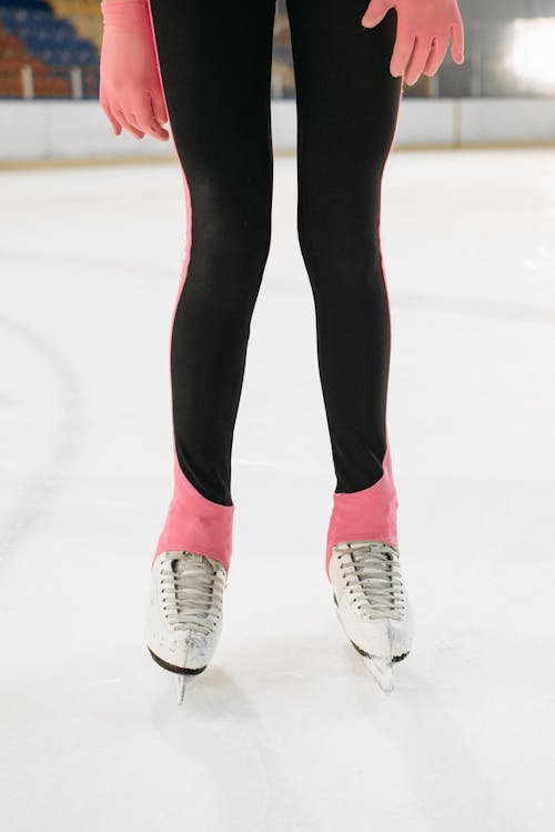 Feet of a Woman Skating on the Ice Rink 