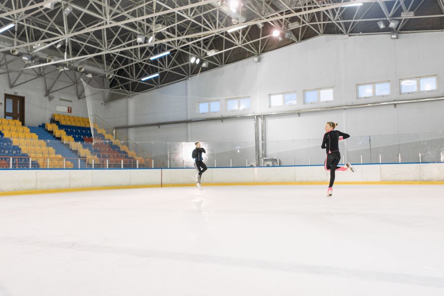 Figure skaters practicing on an ice rink
