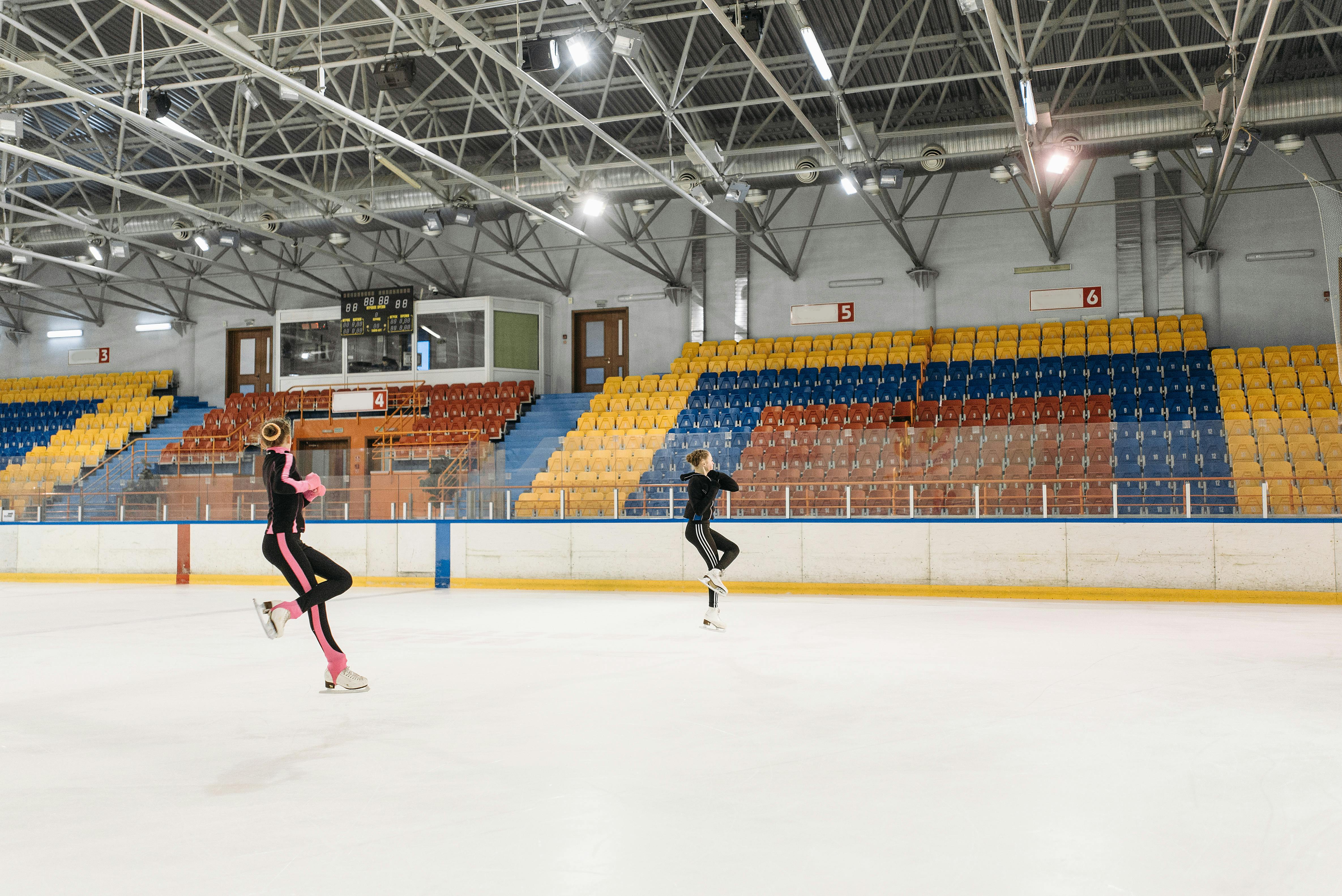 a pair of figure skaters jumping in the air