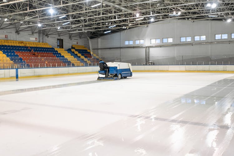 Person Riding A Zamboni On An Ice Skating Rink