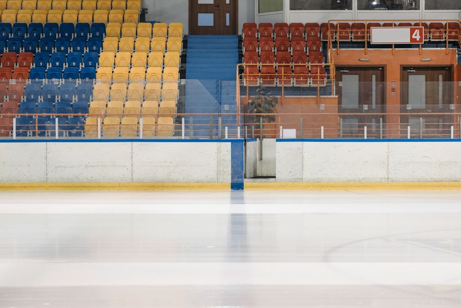 Rink boards and tiered seating in an indoor arena — photo by Pavel Danilyuk on Pexels