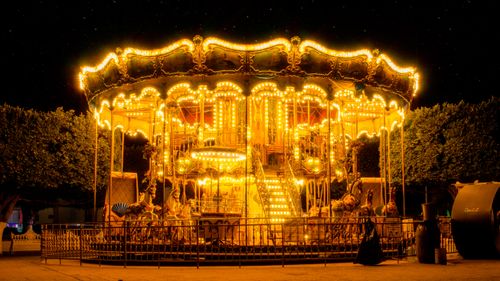 Free Vibrant and illuminated carousel at night in Hidalgo, Mexico, glowing with lights. Stock Photo