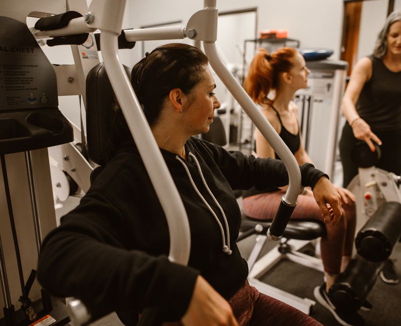 A group of women participating in a personal training session focused on strength training during menopause.
