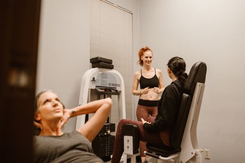 Free Women engaging in fitness routines at an indoor gym, focusing on wellness and health. Stock Photo