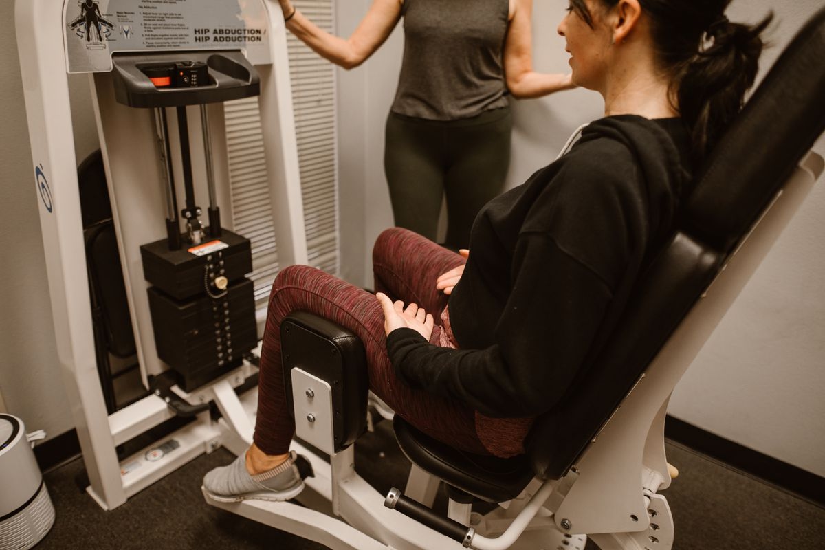 Woman exercising hip region representing hip ultrasound assessment