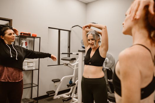 Three women exercising and stretching in a gym, promoting health and wellness.