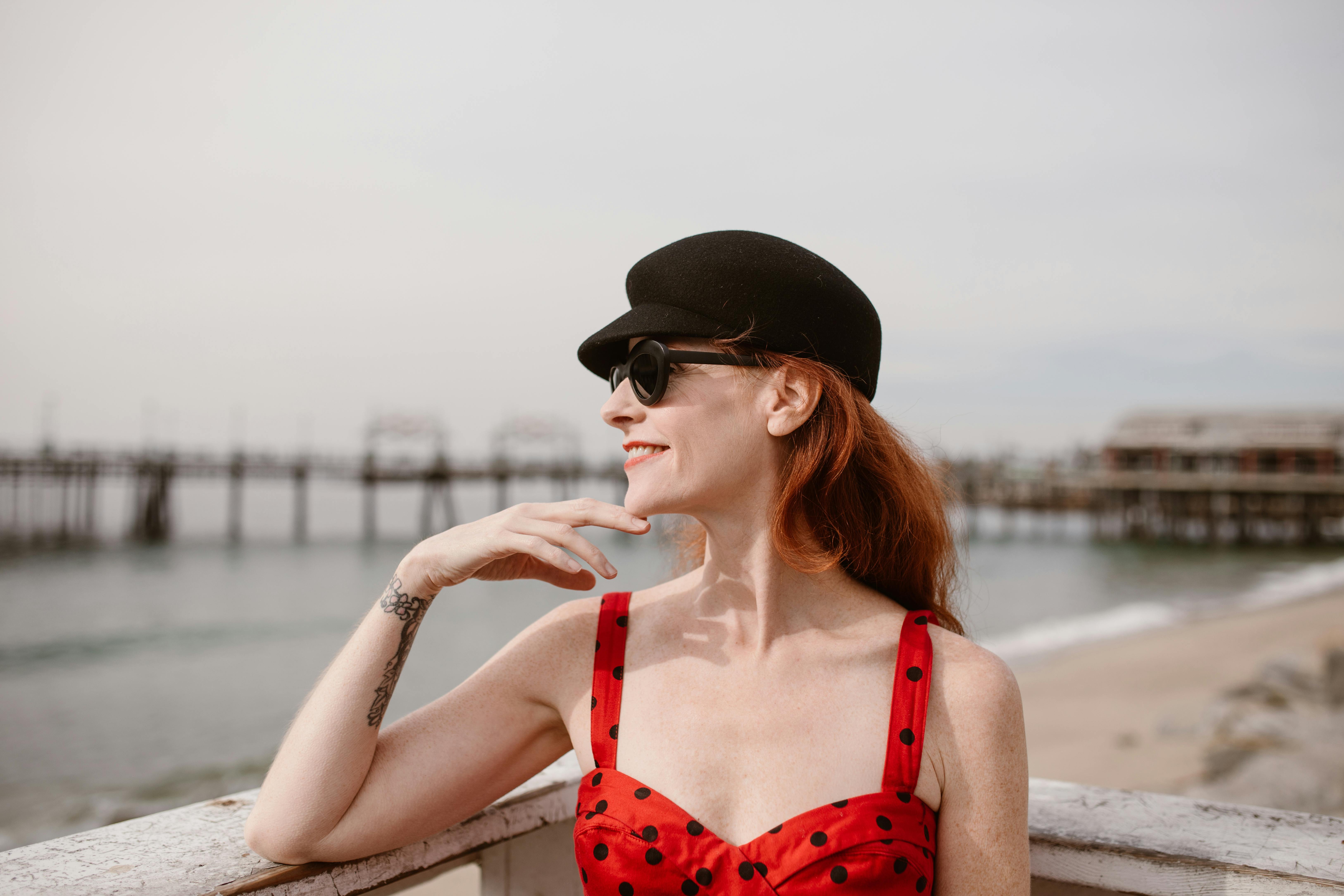 confident woman enjoying sea view and smiling on balcony