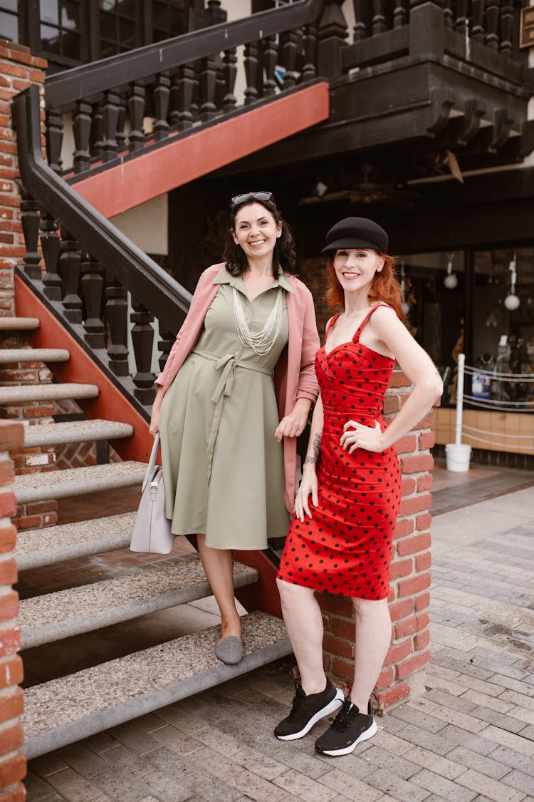 Women In Midi Dresses Posing On Stairs