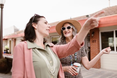 Free Two stylish Caucasian women enjoying a day outdoors, sharing a joyful moment together. Stock Photo