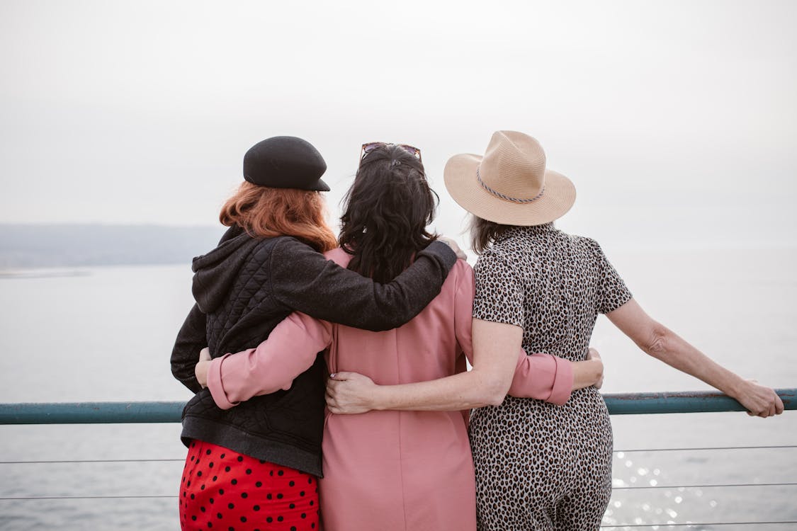Free People Hugging while Looking at the Beach Stock Photo