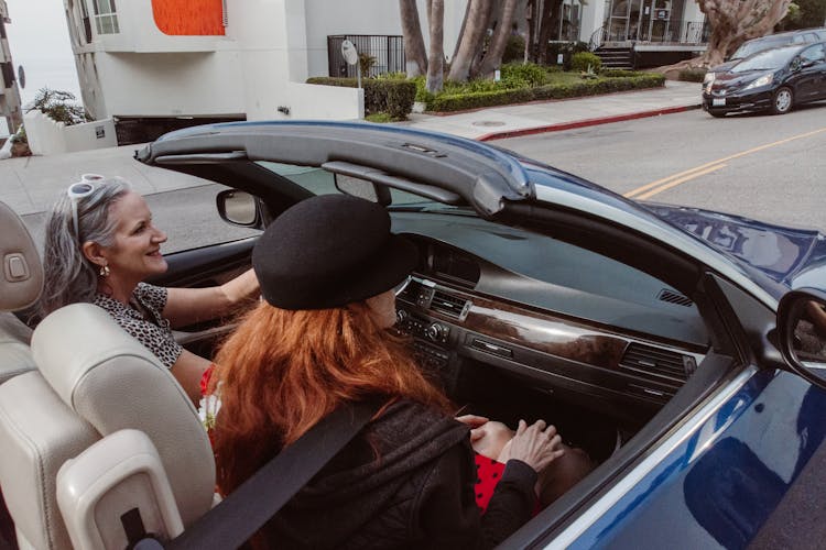 Women Riding A Car On The Road