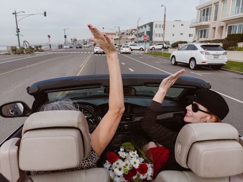 Two People Riding in Convertible Car