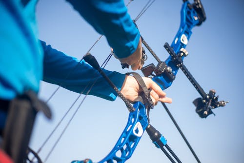 A Person Holding Bow and Arrow Equipment