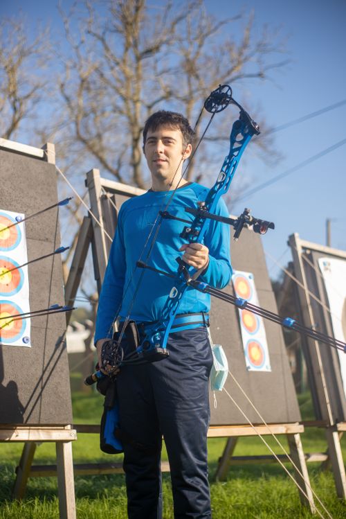 Free A young man practicing archery outdoors in Portugal with a compound bow. Stock Photo