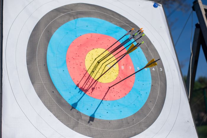 Arrows hitting an archery target bullseye