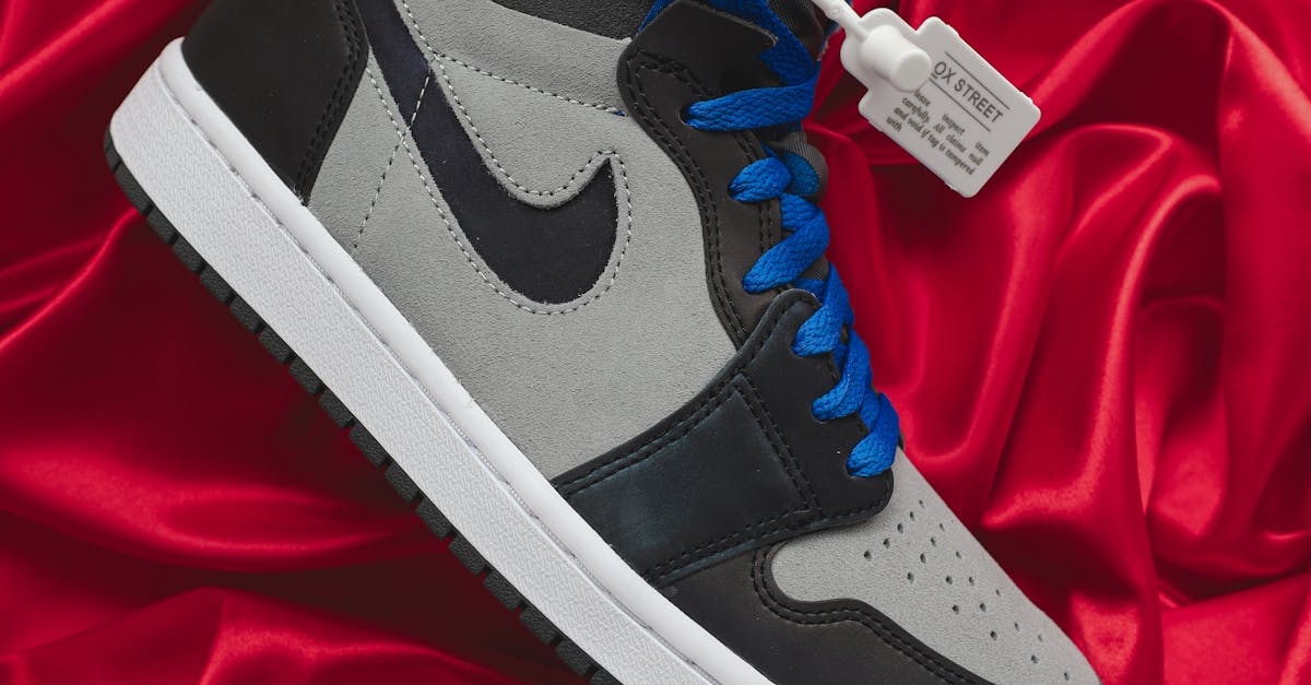 Black and White Nike High Top Sneaker on Red Satin Textile · Free Stock Photo