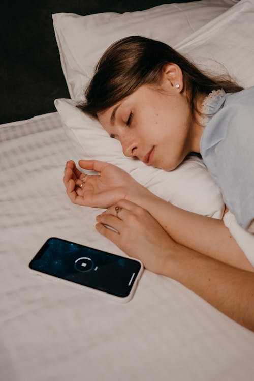 Free Phone beside an Asleep Woman  Stock Photo