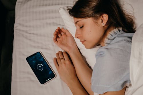 Free Phone beside an Asleep Woman  Stock Photo
