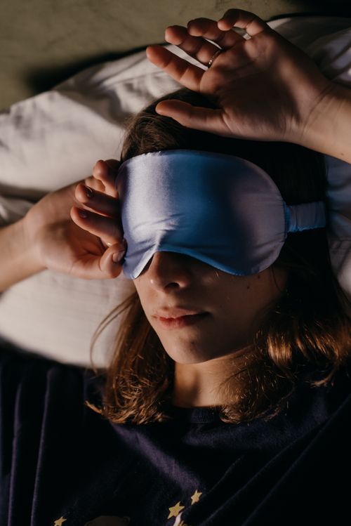 Woman resting with a sleep mask