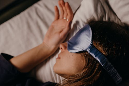 Free Woman Using a Silk Sleep Mask Stock Photo