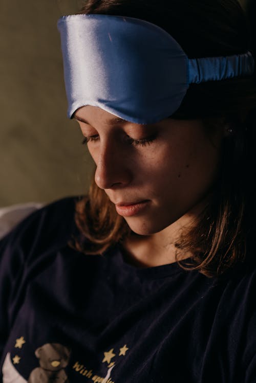 Free Brunette Woman with a Sleep Mask on Her Forehead  Stock Photo