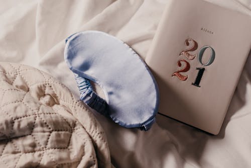 Free Book Beside a Sleeping Mask
 Stock Photo