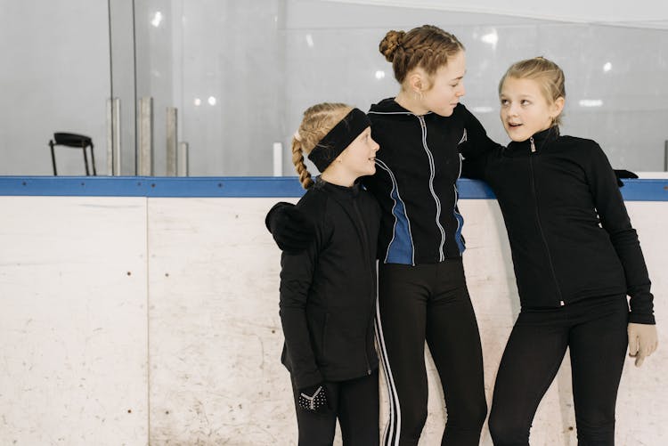 Girls In Black Jackets Standing Close Together