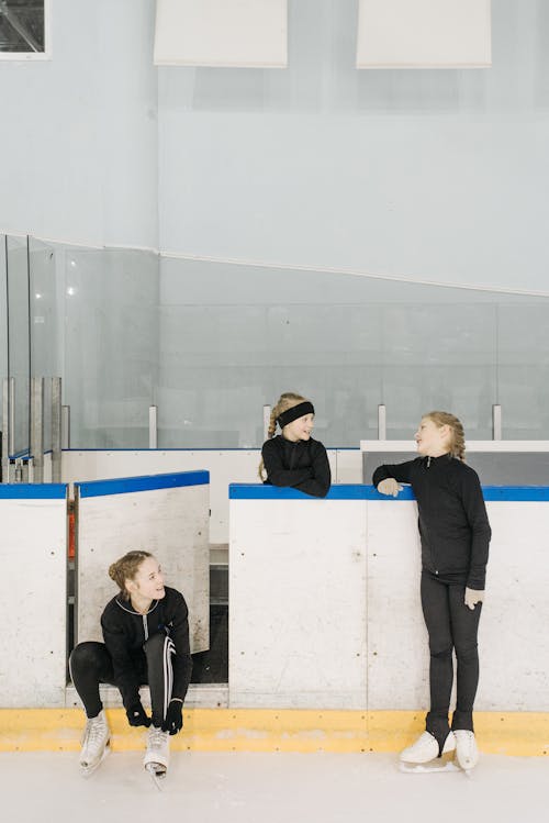 Free Girls Wearing Ice Skates Standing on Skating Rink
 Stock Photo