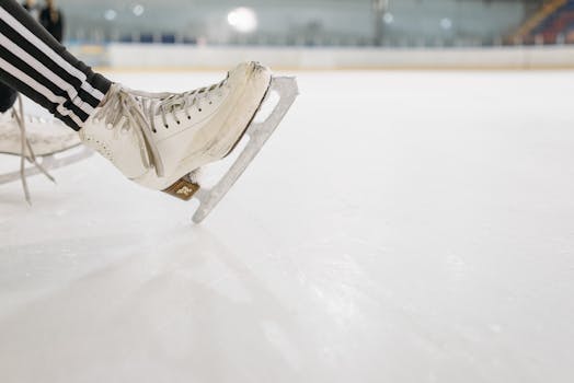 A detailed view of an ice skate resting on a smooth ice rink, perfect for winter sports themes.