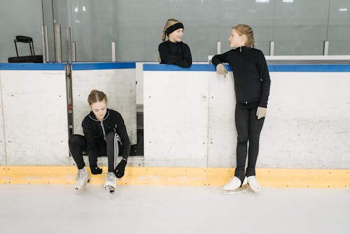 Young Girls Talking Beside an Ice Rink