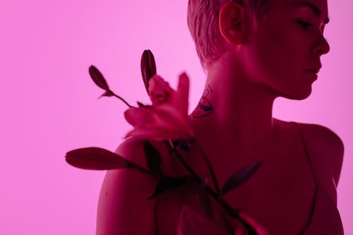 Woman with Flower on Pink Background