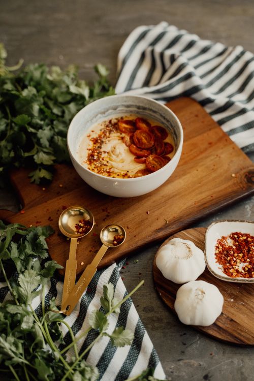 Free Delicious vegan hummus with spices on rustic board. Perfect for a healthy snack. Stock Photo