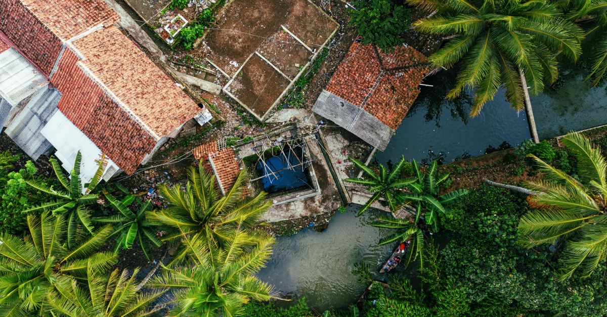 A stunning aerial shot showcasing lush foliage and rooftops in Rumpin, Indonesia.