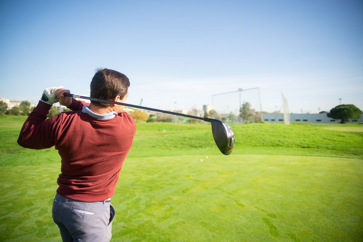 Golfer at the finish, viewed down the line