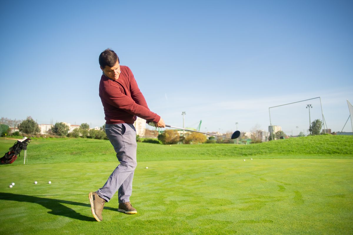 Golfer swinging on the course, filmed for swing analysis
