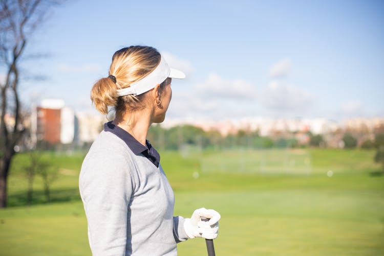 A Woman In White Sun Visor Cap