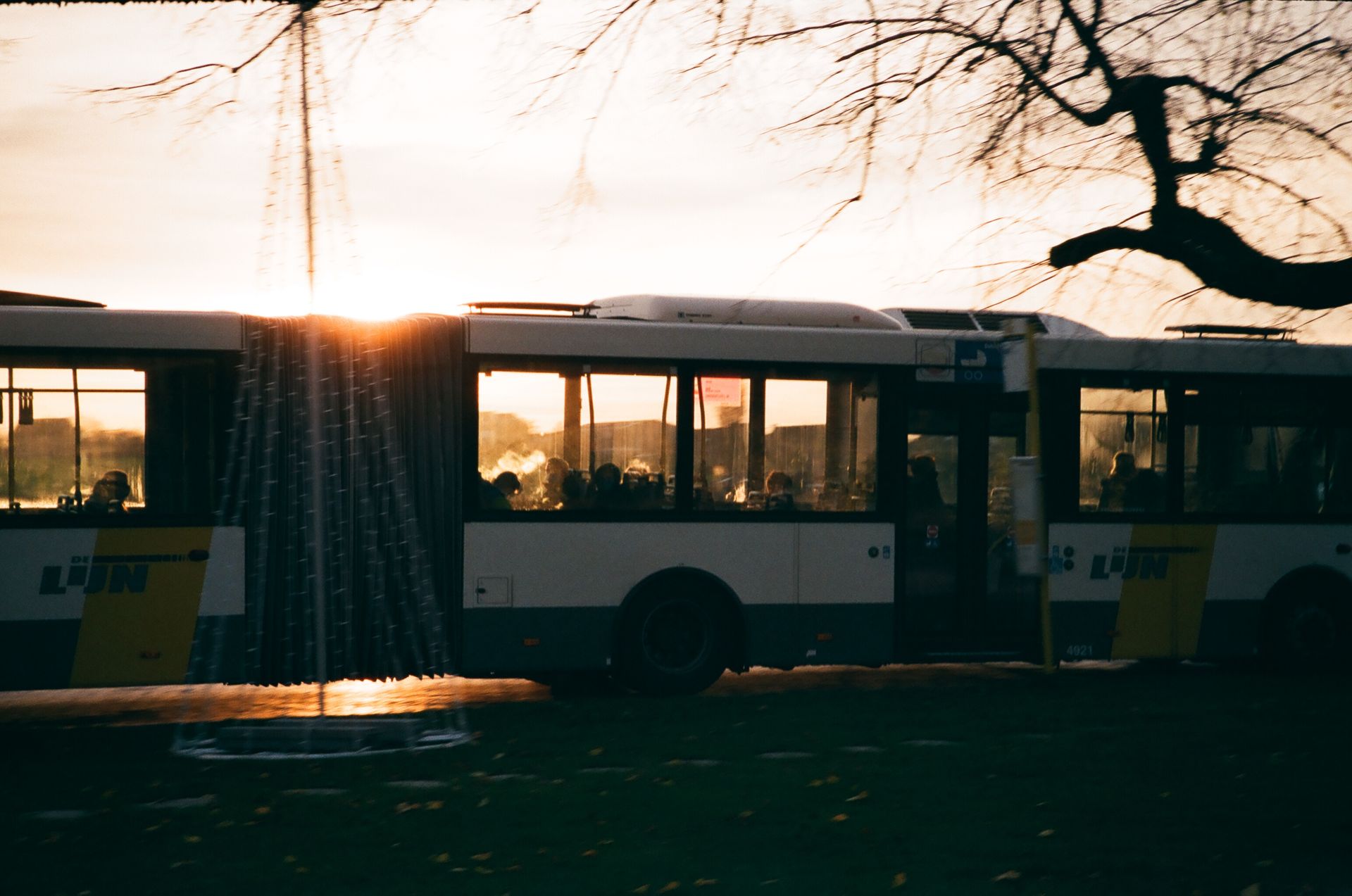 Modern coach bus driving on a highway at sundown