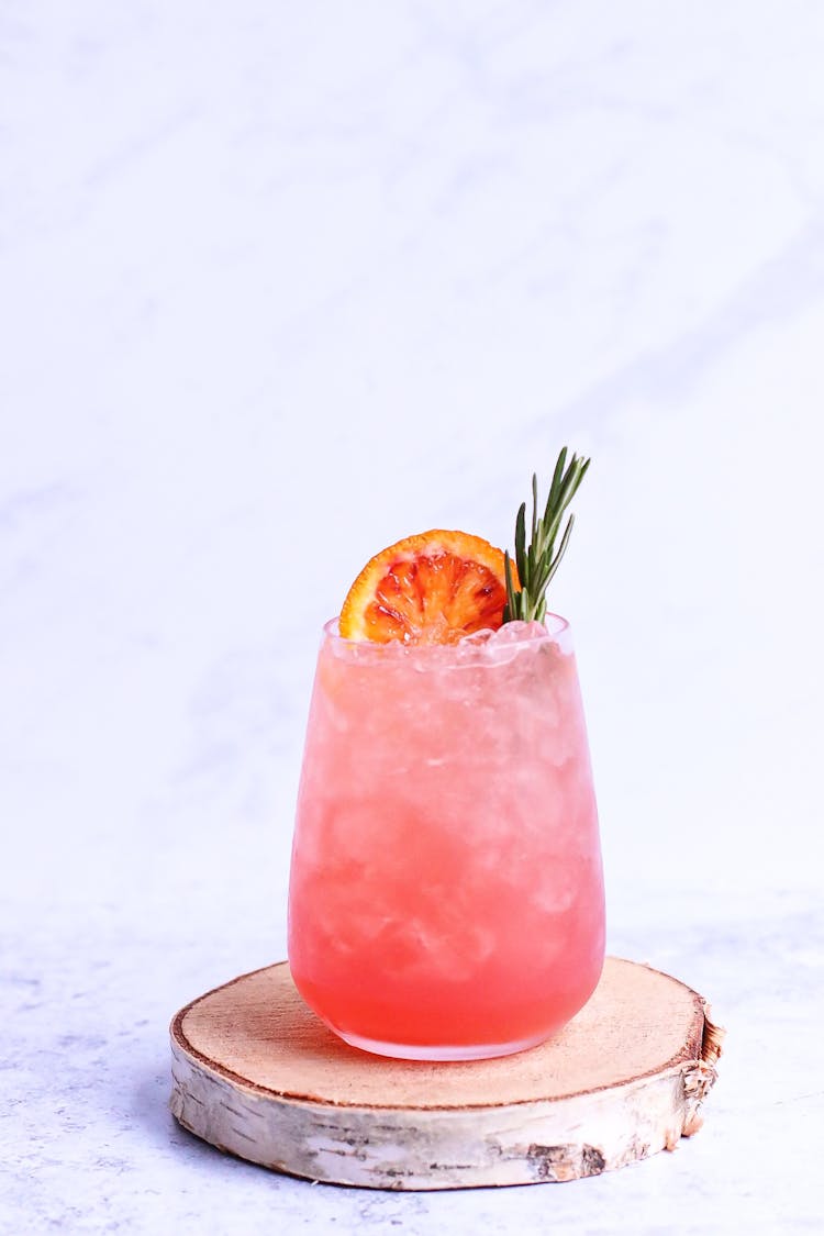 Tasty Beverage With Orange Slice And Rosemary Sprig