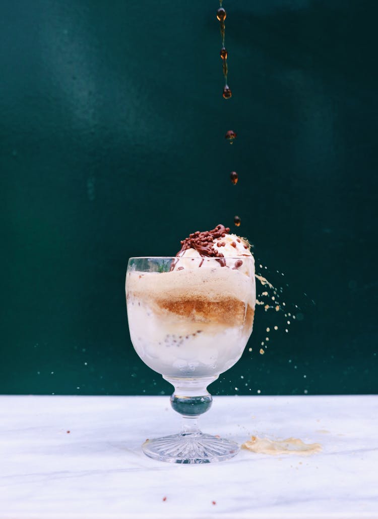 Chocolate Syrup Dropping On Delicious Ice Cream