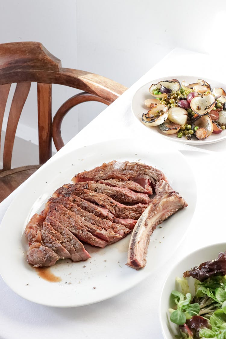 Appetizing Ribeye Steak Served On Table With Delicious Salad