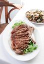 Appetizing steak served on table with mussel salad