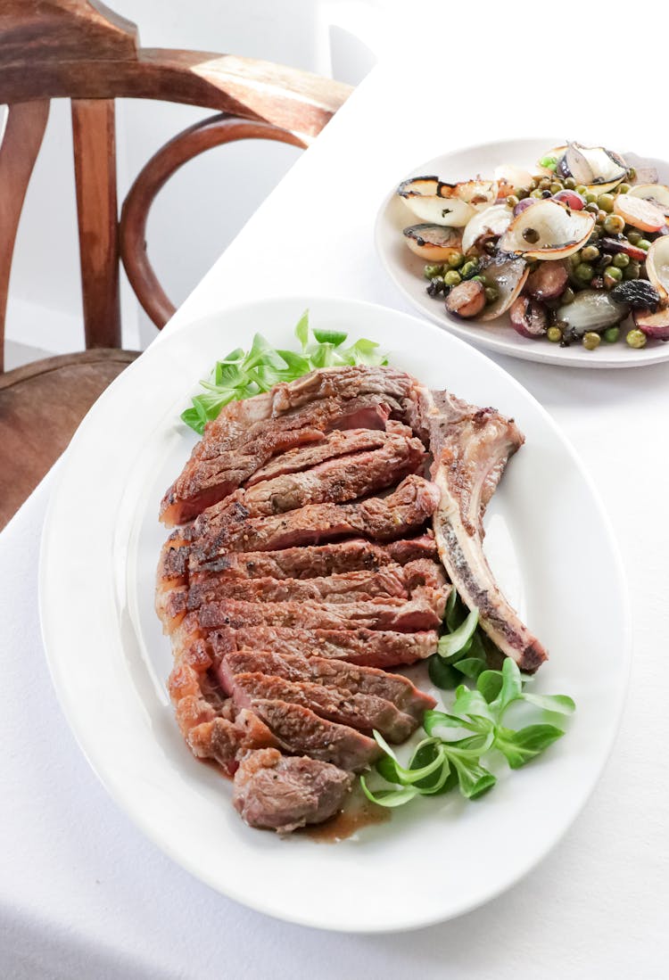 Appetizing Steak Served On Table With Mussel Salad