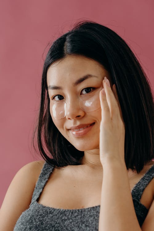 A Smiling Woman with Her Hand on Her Face