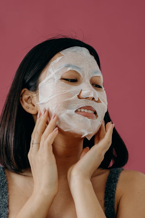 A Woman Touching Her Face with Mask