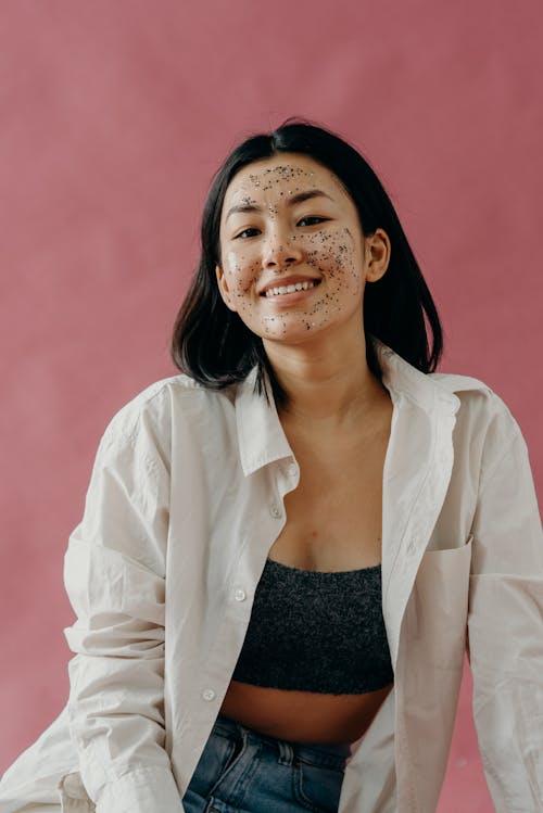 A Woman in White Long Sleeves with Glitter Mask on Her Face
