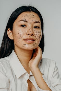 Asian woman enjoying a skincare routine with an exfoliating face mask, promoting healthy skin.