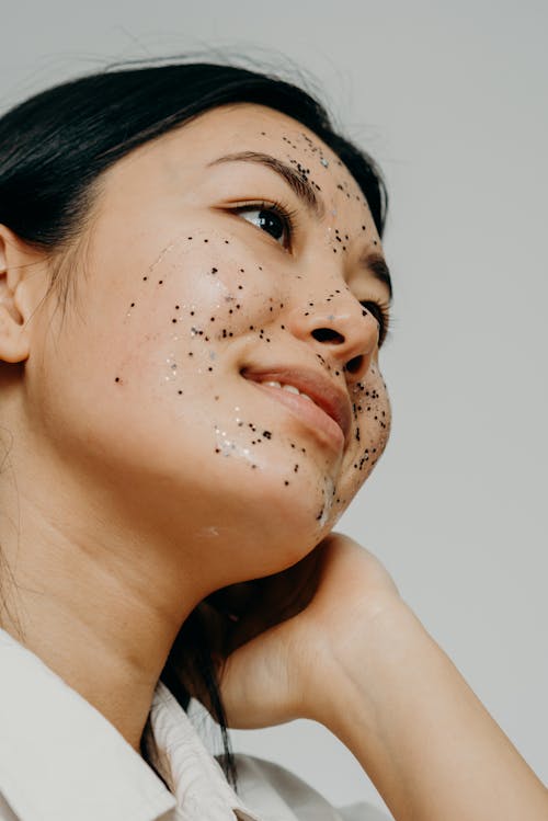 A Smiling Woman with Glitters on Her Face